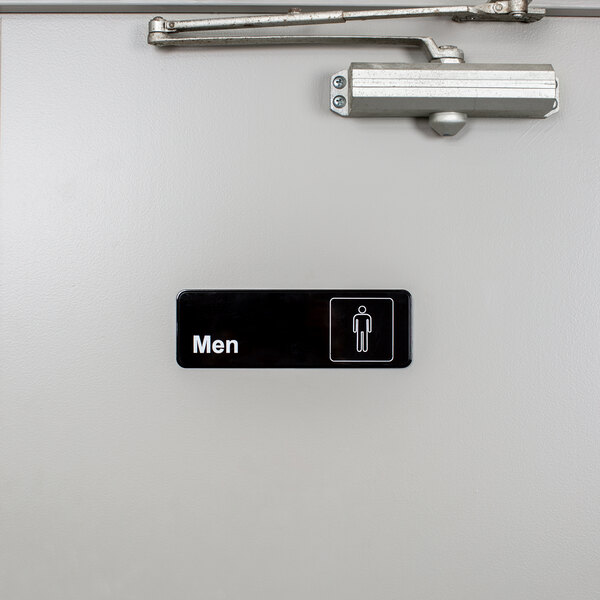 A black and white rectangular sign with the words "Men's Restroom" and a man icon.