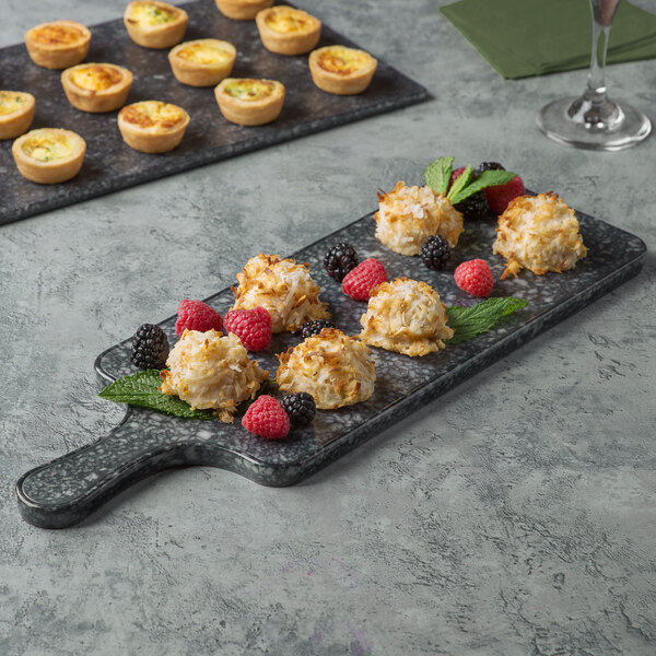 A Thunder Group Onyx Faux Marble melamine serving board with fruit and berry desserts on it.