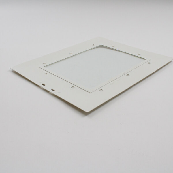 A white rectangular object with a glass window and a white square frame with screws.