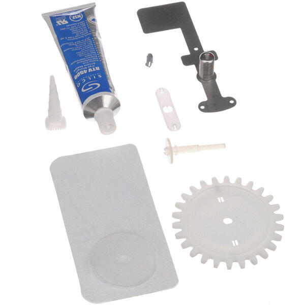 A white tube of Amana microwave antenna parts including a screw, gear, and screwdriver.