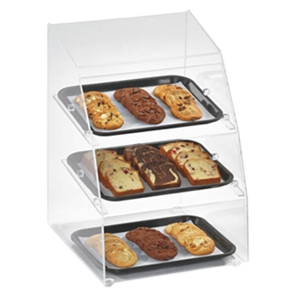 A Vollrath bakery display case with three trays of cookies on display.