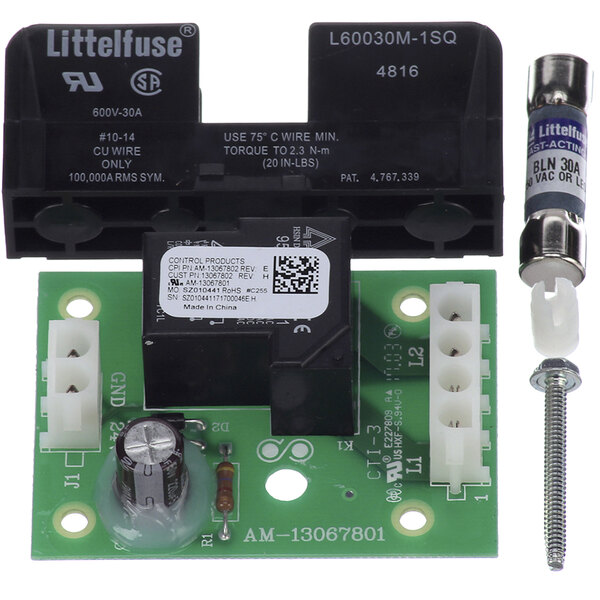 A green electronic control board for an Amana commercial microwave with black and white objects.