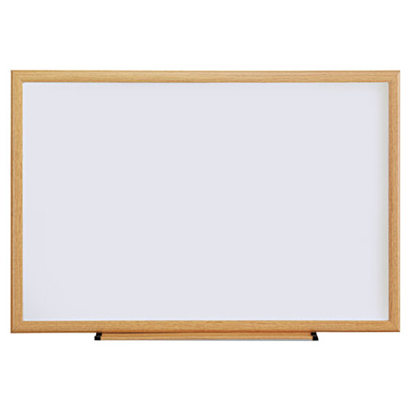 A Universal white melamine dry-erase board with an oak frame.