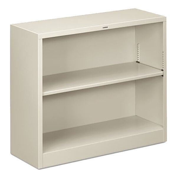 A light gray HON metal bookcase with two shelves.