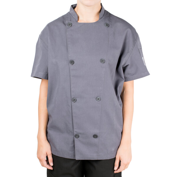 A person wearing a Chef Revival gray short sleeve chef jacket with mesh back.