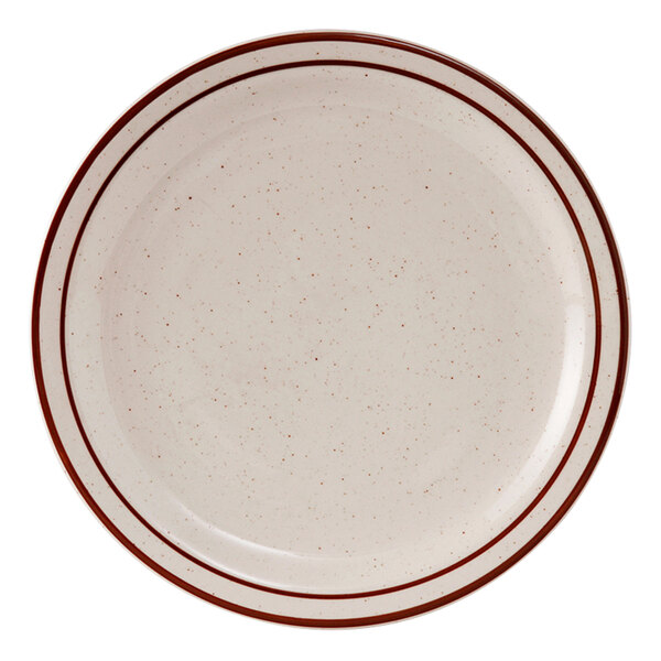 A white Tuxton china plate with brown speckled narrow rim.