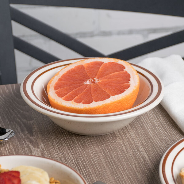 A bowl of grapefruit on a table.
