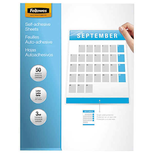 A hand holding a calendar with a Fellowes white and black label.