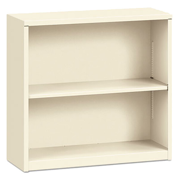 A putty metal bookcase with two shelves.