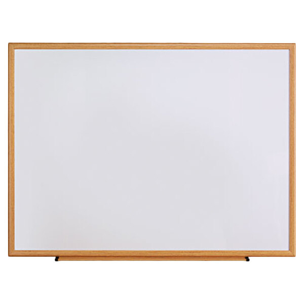 A Universal white melamine dry-erase board with an oak frame.