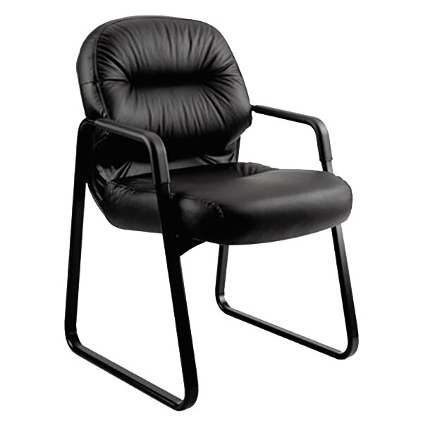 A HON black leather guest arm chair with black metal legs.