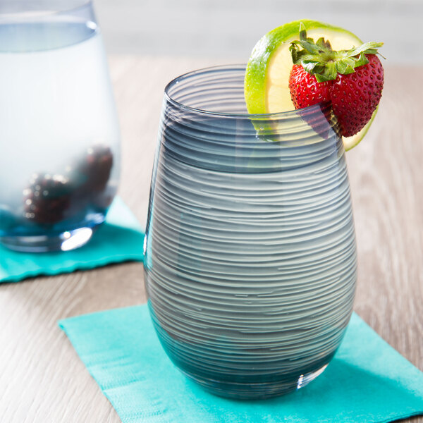 A Stolzle smoky grey stemless wine glass with a strawberry and lime slice on the rim.