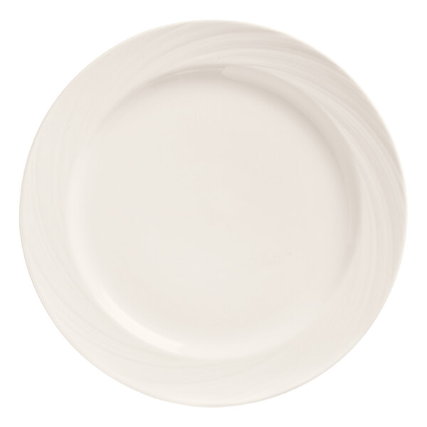 A close up of a Libbey bright white porcelain plate with swirls on the rim.