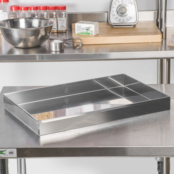 A Matfer Bourgeat stainless steel rectangular cake pan on a table.