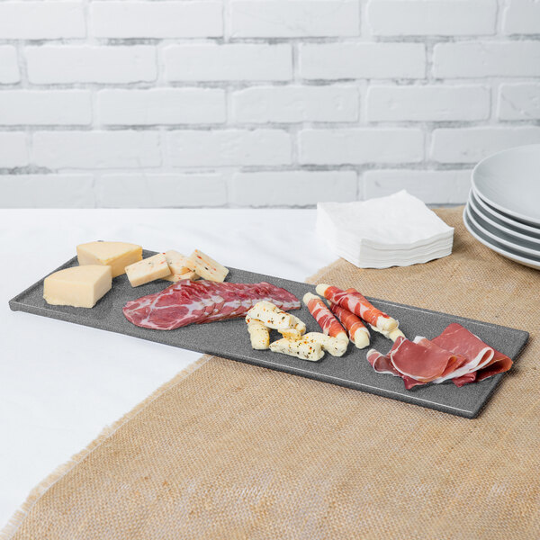 A Tablecraft granite cast aluminum rectangular platter with meat and cheese on it.
