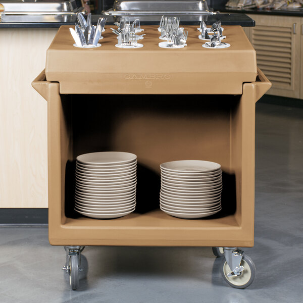 A Cambro coffee beige dish cart with plates and bowls on it.