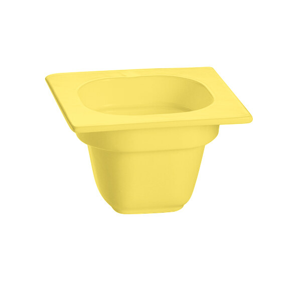 A yellow square food pan with a square top.