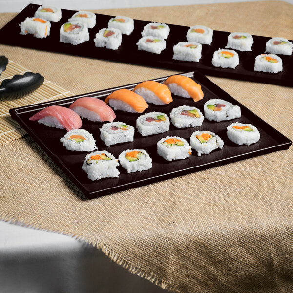A Tablecraft midnight speckle cast aluminum rectangular cooling platter with sushi on it.