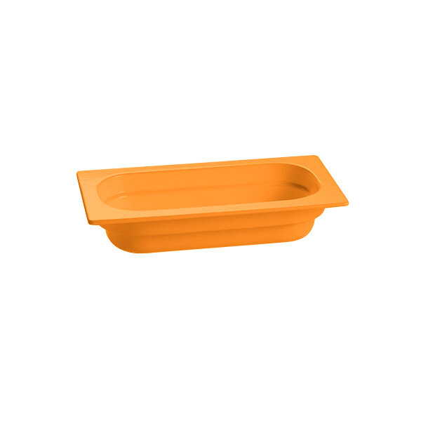 An orange rectangular Tablecraft cast aluminum food pan on a counter.