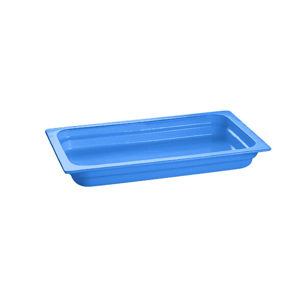 A cobalt blue rectangular cast aluminum food pan on a white counter.