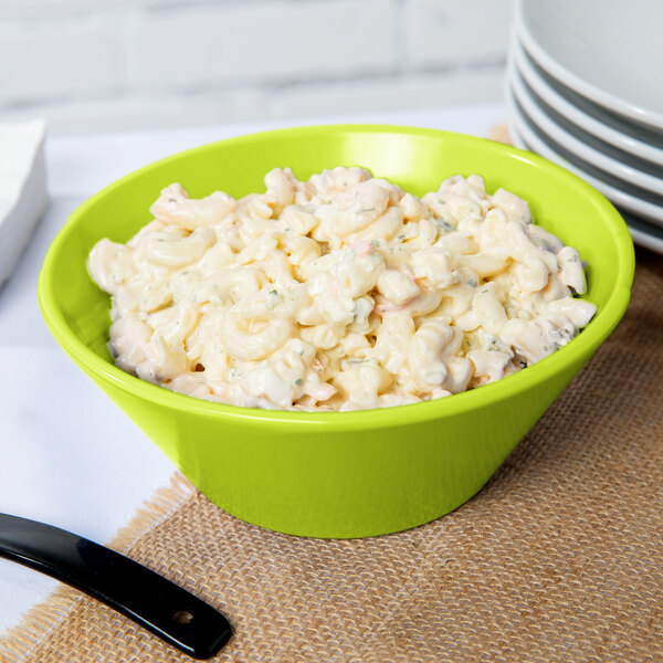 A Tablecraft lime green cast aluminum serving bowl filled with macaroni salad.