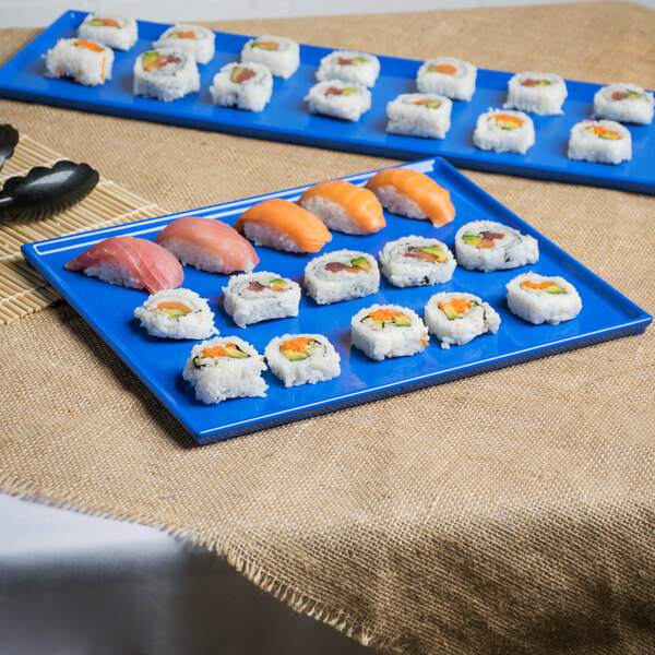 A blue Tablecraft rectangular cast aluminum cooling platter with sushi on it.