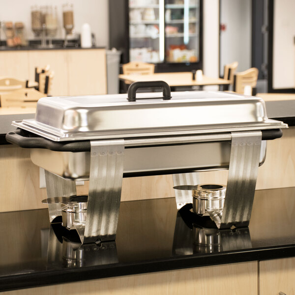 A Vollrath stainless steel rectangular chafer on a counter.
