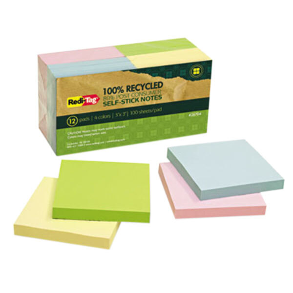A box of Redi-Tag assorted color self-stick notes on a pink surface.