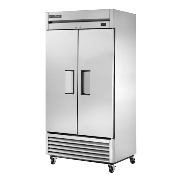 A True stainless steel reach-in freezer with solid doors.