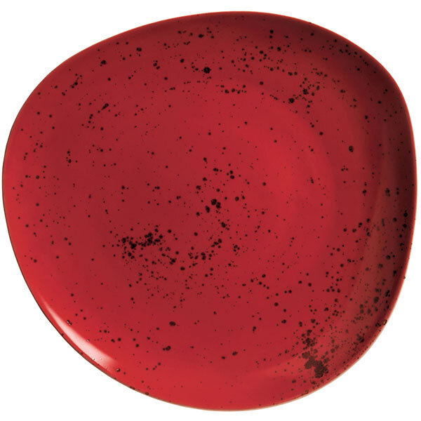 A red Schonwald porcelain plate with black specks.
