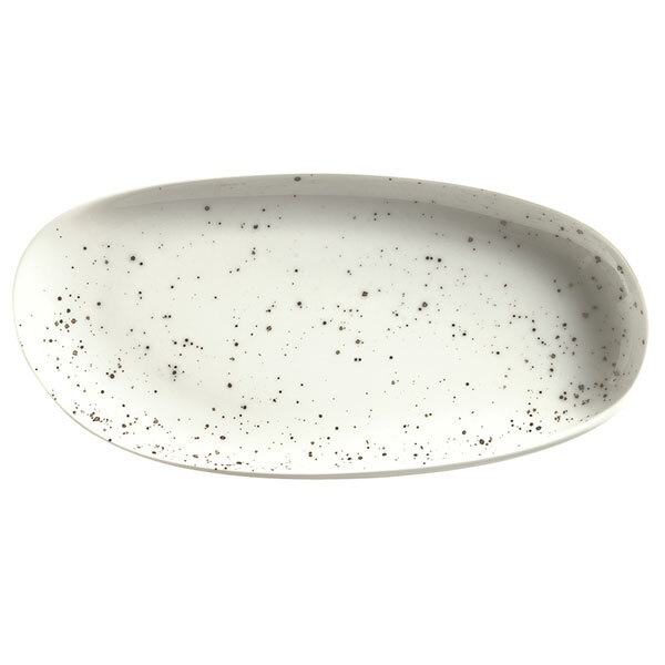 A white oval Schonwald porcelain platter with black specks.