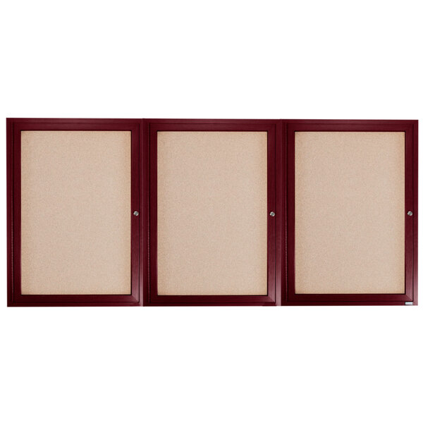 Three wooden framed bulletin boards with cherry wood doors.