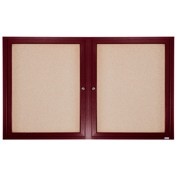 A wood-framed enclosed bulletin board with cork panels and two doors.
