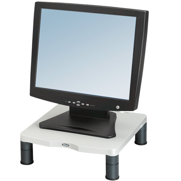 A black computer monitor on a Fellowes monitor riser.