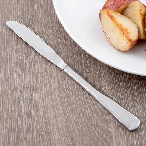 A plate of potatoes and a World Tableware Columbus stainless steel knife.