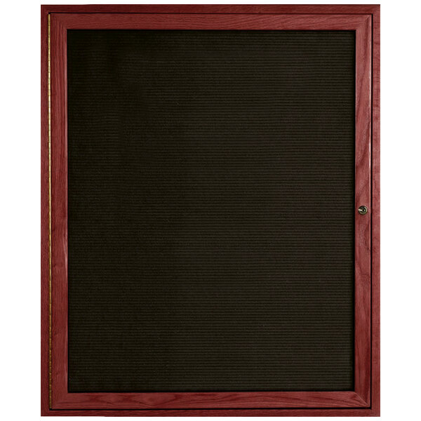 A black board with a wooden frame and enclosed door.