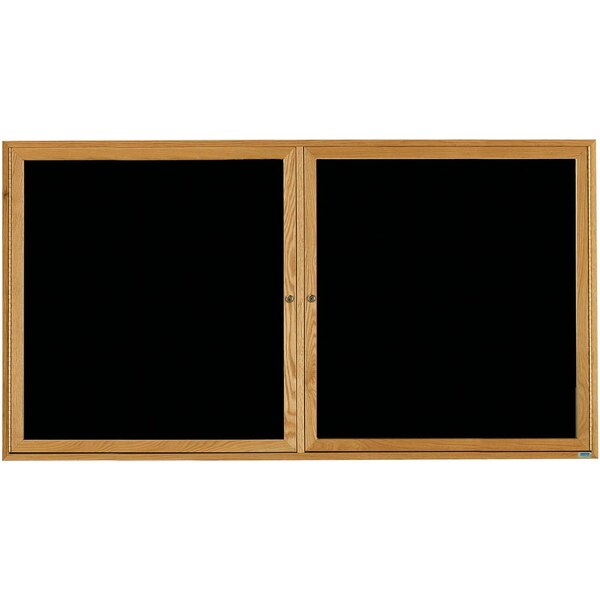 Two Aarco black felt message boards with natural oak frames and black glass doors.