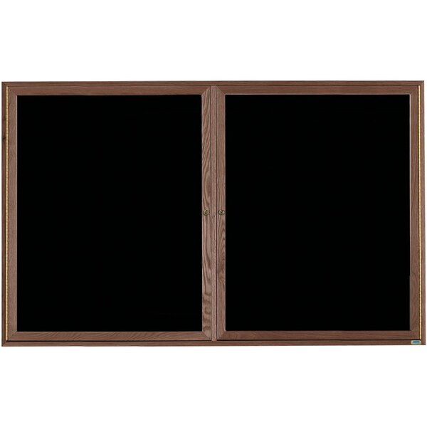 A black felt message board with a walnut frame and two black doors.