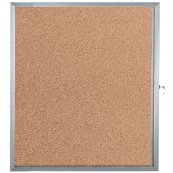 A cork bulletin board with a silver aluminum frame and lock.