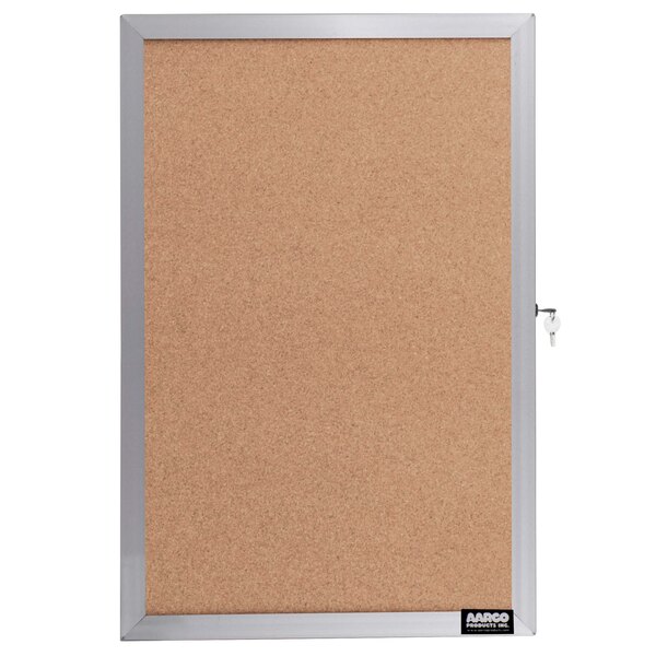 An Aarco cork bulletin board with a silver aluminum frame and a key lock.