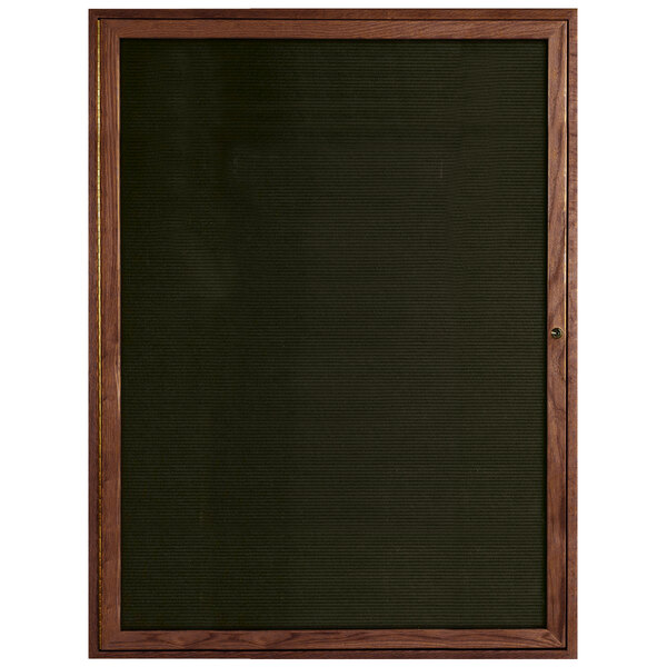 A wooden framed black Aarco message board.