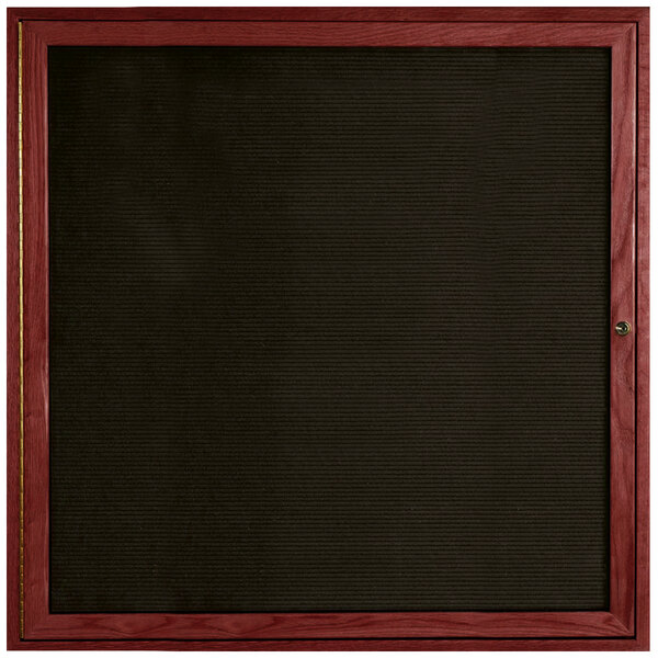 An enclosed black felt message board with a cherry frame.