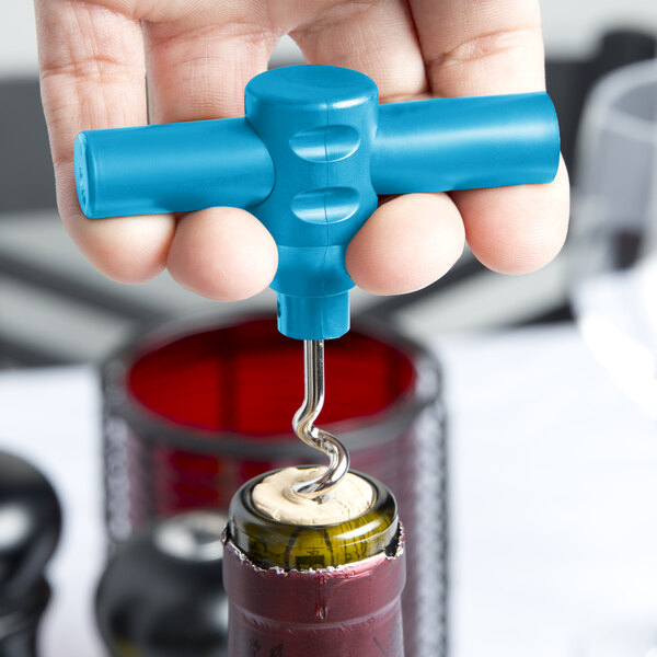 A hand using a Franmara turquoise plastic pocket corkscrew to open a wine bottle with a cork.