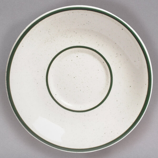 A white Tuxton saucer with a narrow green rim.