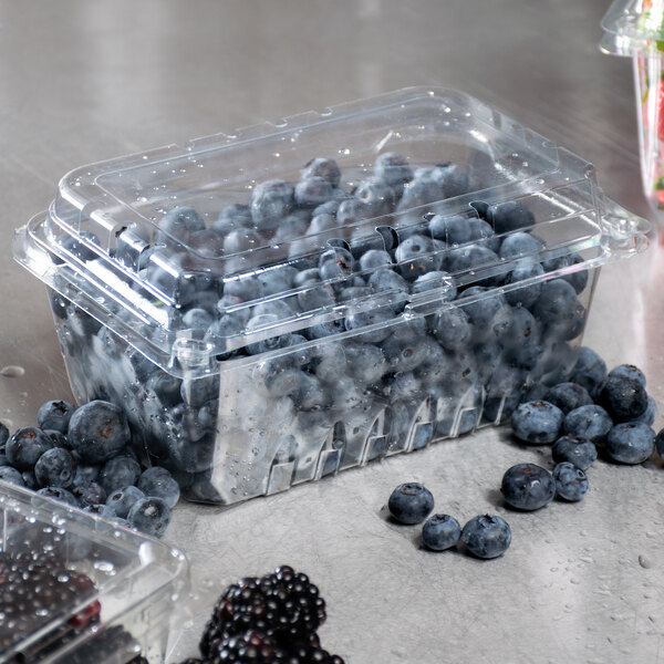 A 1 lb. clear vented plastic clamshell container of blueberries and blackberries.