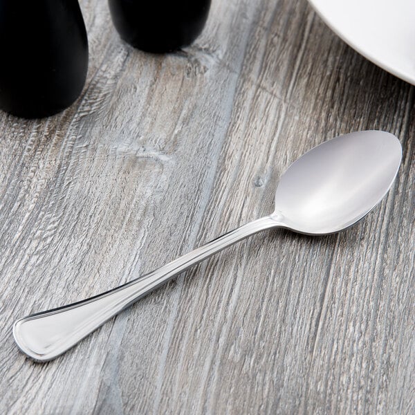 A Libbey stainless steel serving spoon with a silver handle on a table.