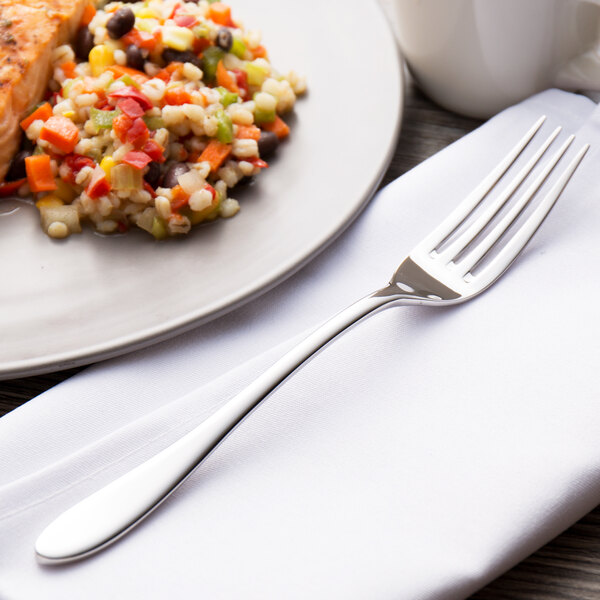 A Chef & Sommelier stainless steel dinner fork on a plate with food.