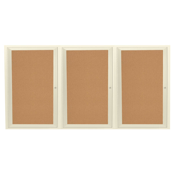 An ivory Aarco enclosed bulletin board cabinet with 3 cork boards behind 3 doors.