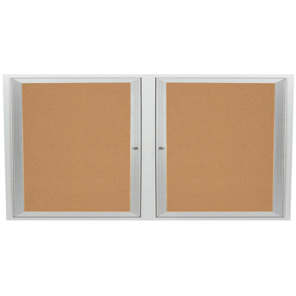An Aarco satin anodized finish enclosed bulletin board cabinet with two cork bulletin boards.