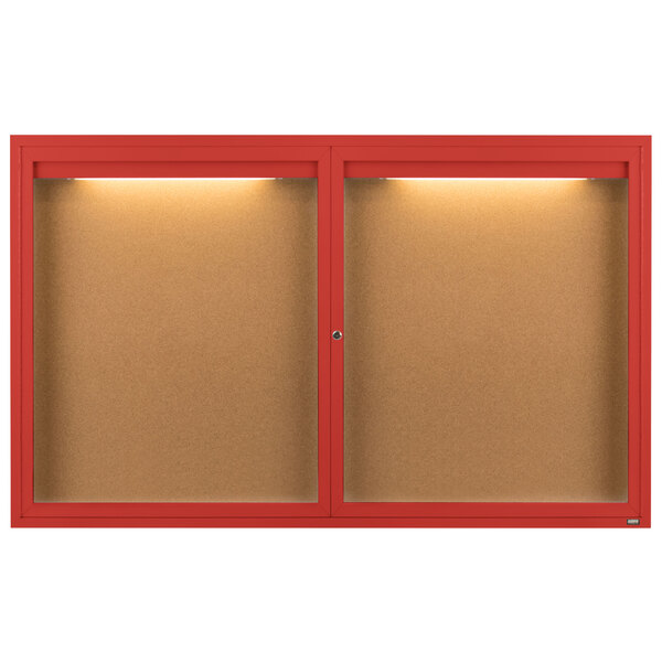 A red Aarco enclosed bulletin board with lights on the doors.
